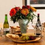 The Byre table set with wine, cheese, fruit, biscuits, flowers Field House